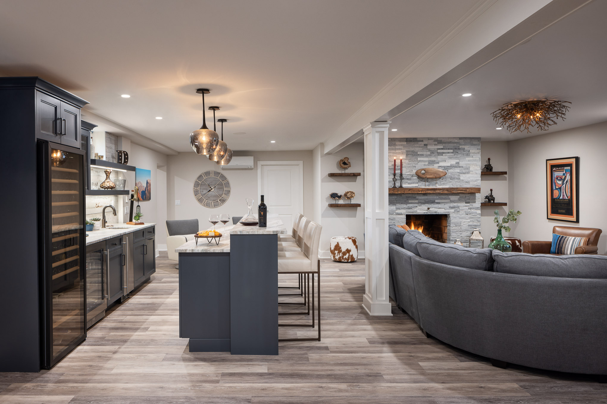 Modern basement with home bar and cozy fireplace lounge