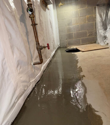 Finished, dry basement with restored slab and wall vapor barrier — Silver Spring, MD