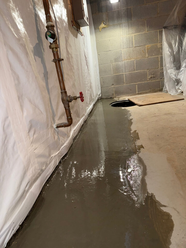 Finished, dry basement with restored slab and wall vapor barrier — Silver Spring, MD