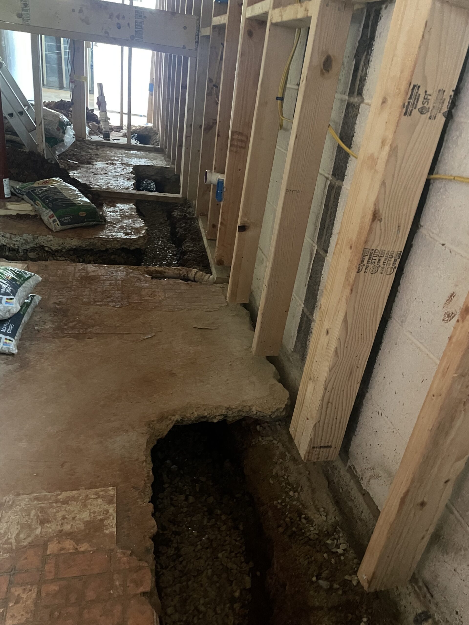 Interior perimeter trench opened in stages along the foundation footing — Manassas, VA