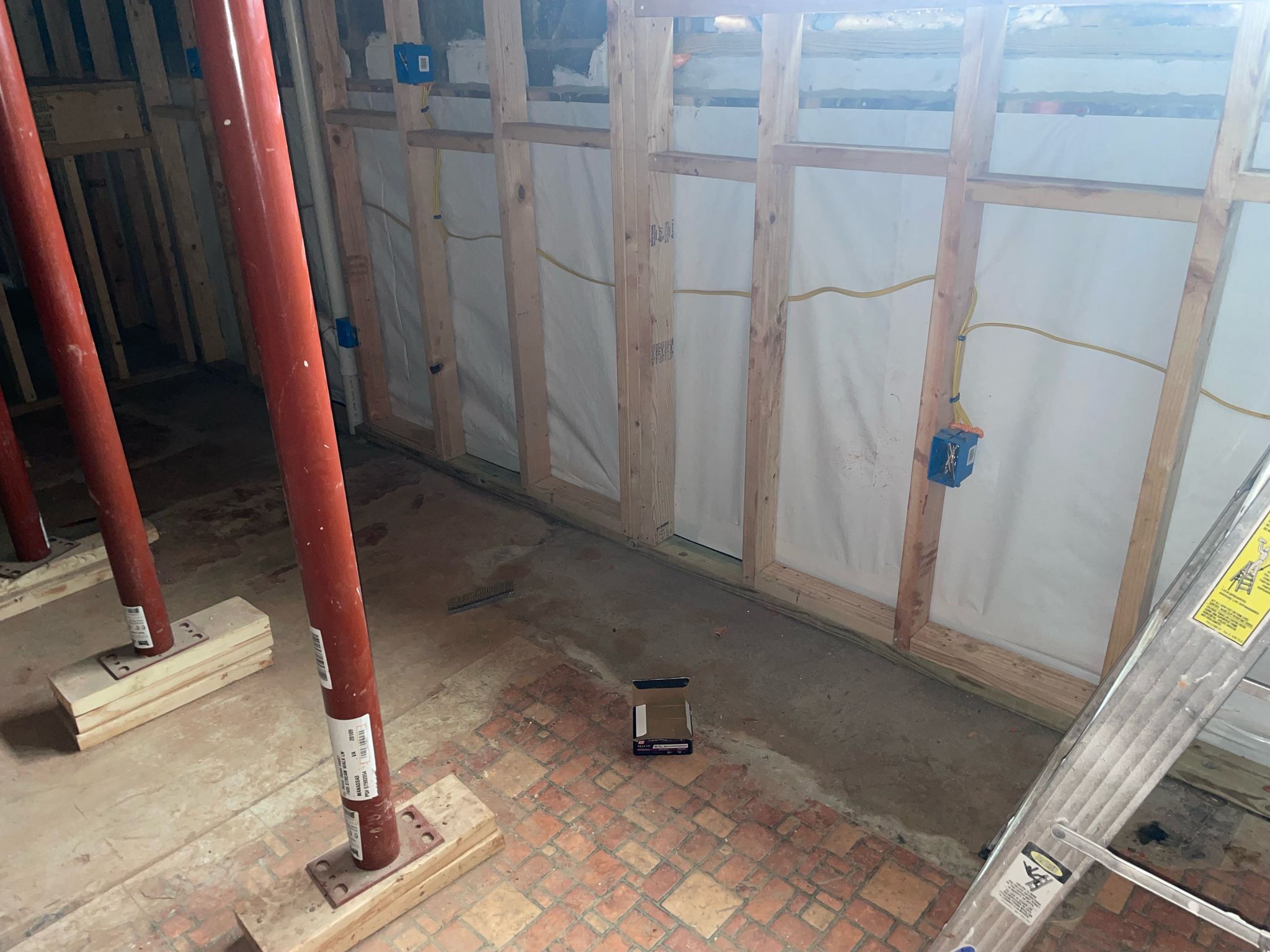Dried, reinforced large basement with wall vapor barrier and steel support posts — Manassas, VA