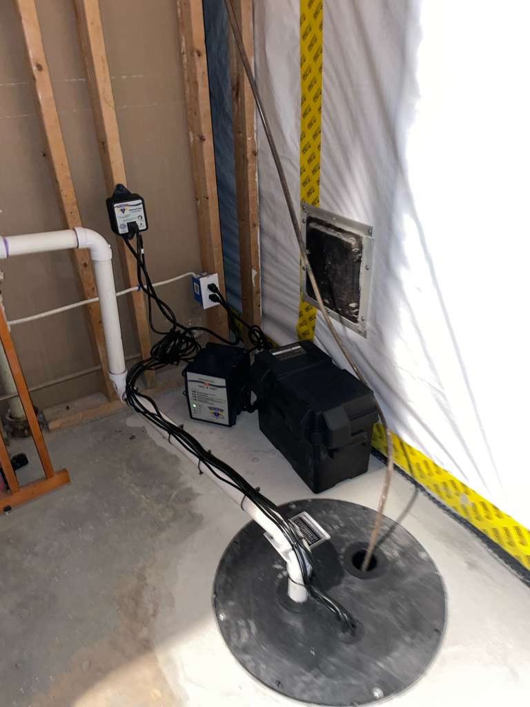 After — the new sump pump with battery backup that keeps the Olney, MD basement dry during storms