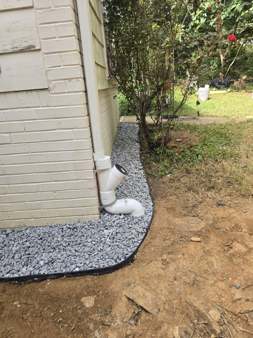 New downspout carrying roof water away from the foundation