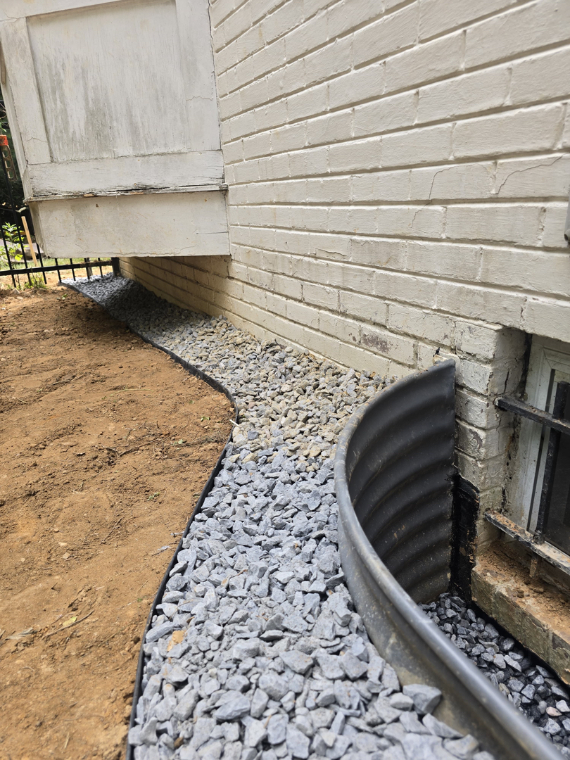 Finished clean-stone drainage perimeter and rebuilt window well