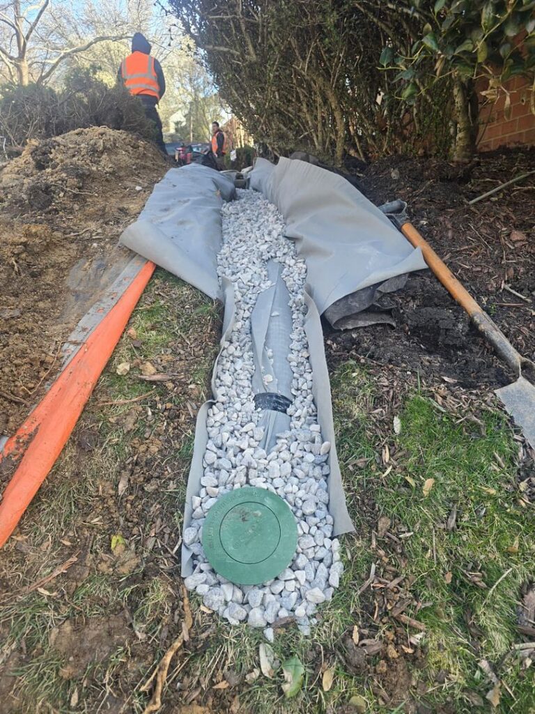 Silver Spring Exterior Drain: 41-Foot Work-Scope Review 1 Geotextile lining an open exterior drainage trench with gravel during installation in Silver Spring, Maryland