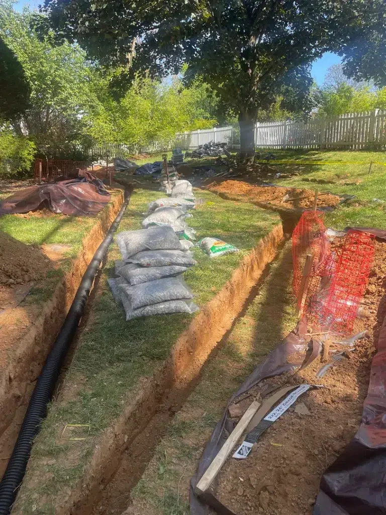 Yard French drain trench during installation at a Gaithersburg, Maryland home