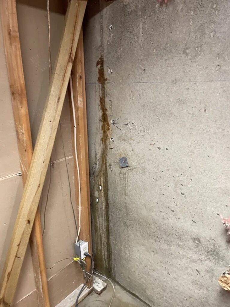 Polyurethane injection packers along a concrete basement-wall crack during a Rockville repair