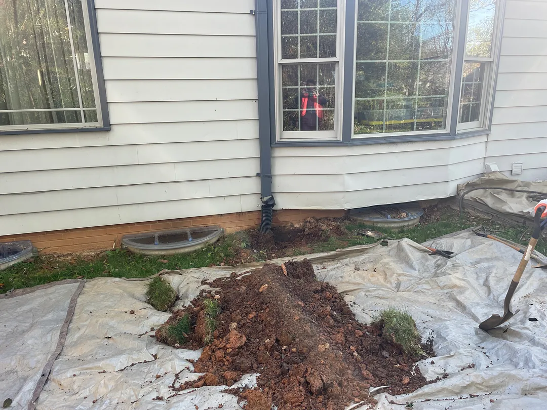 Exterior Waterproofing in Rockville, MD: Windowed Foundation Wall Case 1 Rockville foundation wall with basement window wells as exterior excavation begins
