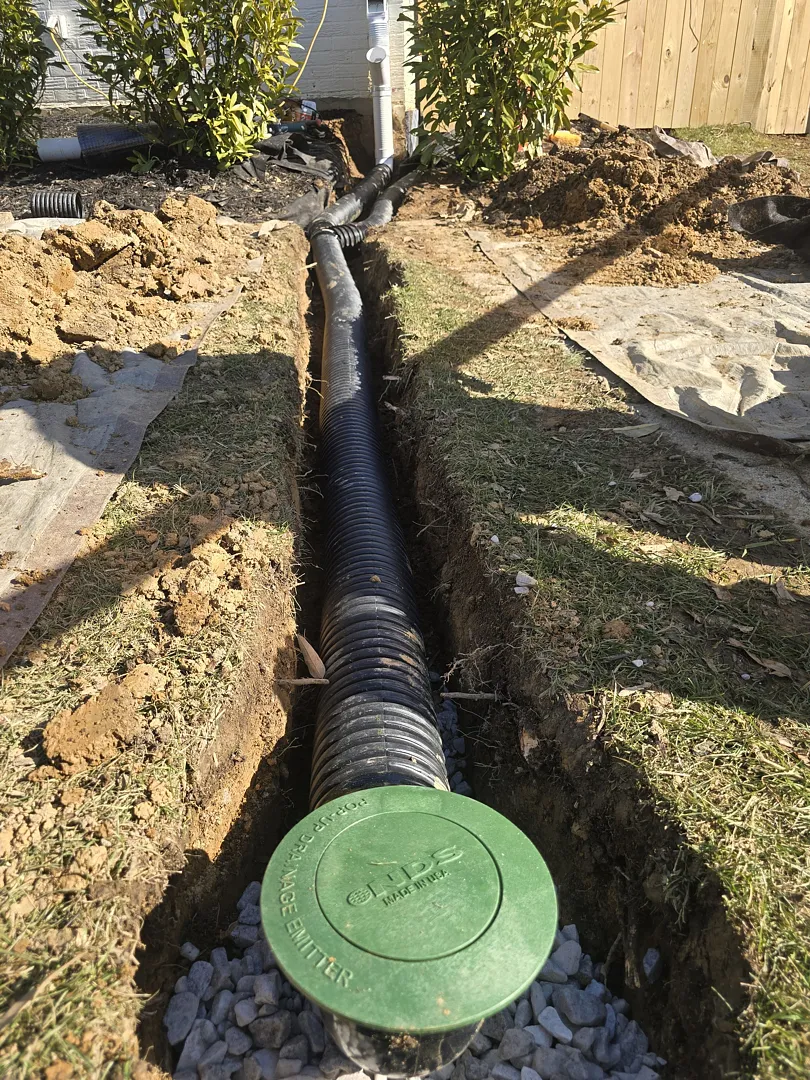 Bethesda, MD Foundation Leak: Exterior Waterproofing and Grading Tile 5 Separate solid drainage discharge route and pop-up outlet in the yard