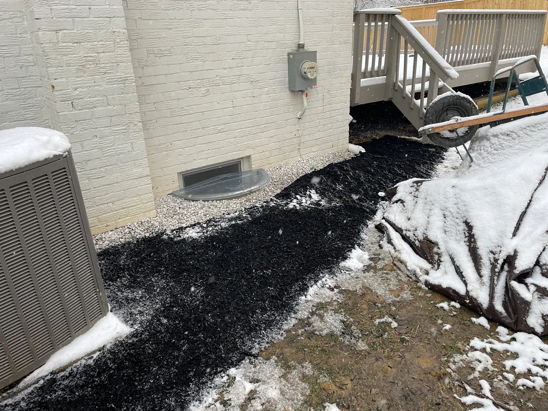 Bethesda, MD Foundation Leak: Exterior Waterproofing and Grading Tile 6 Finished Bethesda side yard with white stone and mulch after waterproofing