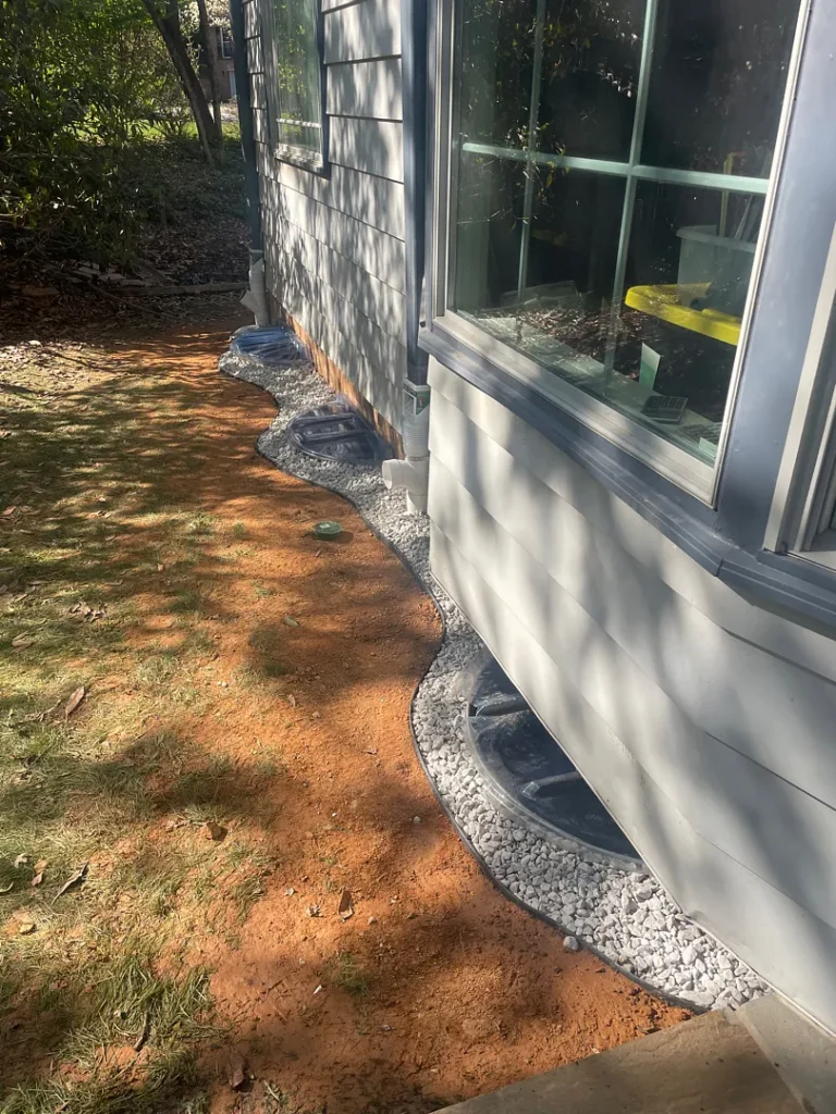 Finished Rockville exterior waterproofing project with restored soil and near-grade gravel band
