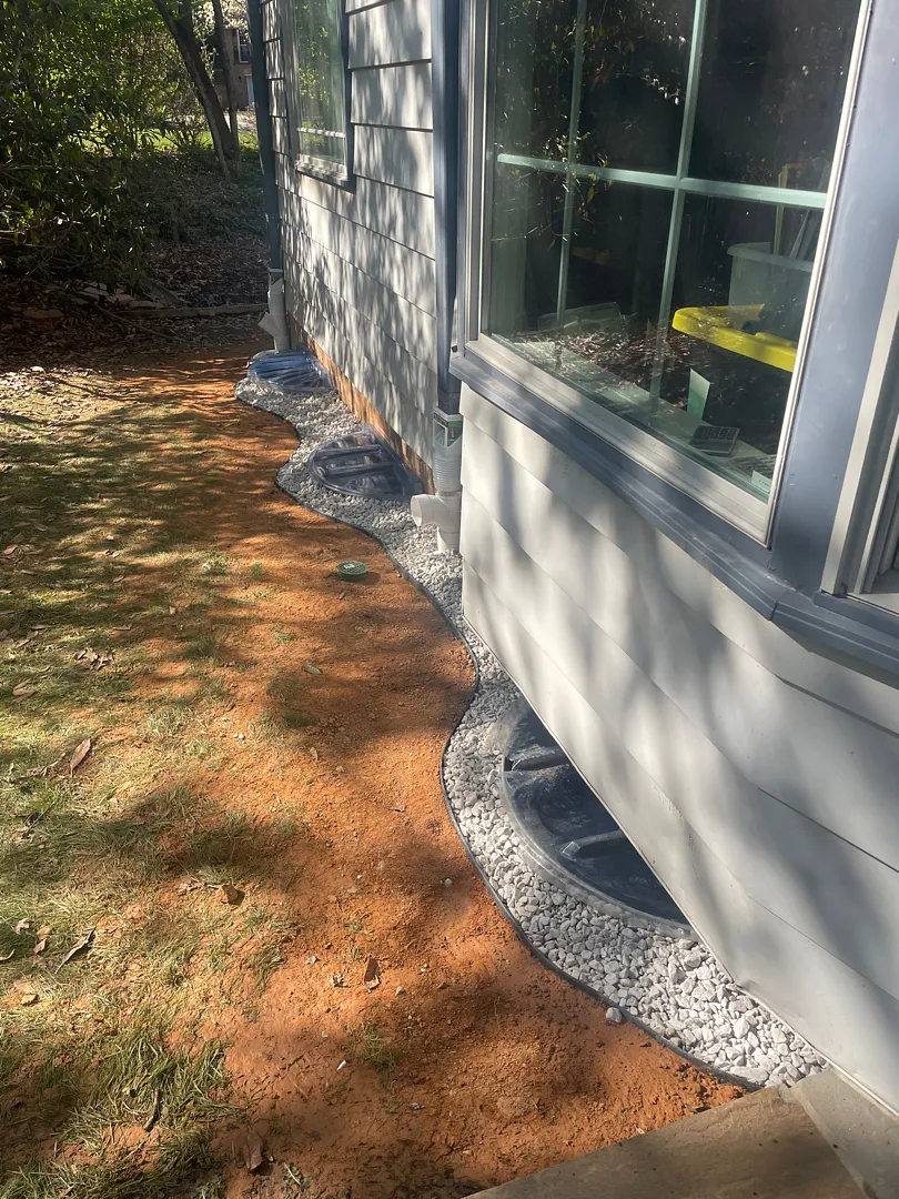 Exterior Waterproofing in Rockville, MD: Windowed Foundation Wall Case 9 Finished Rockville exterior waterproofing project with restored soil and grading tile gravel strip