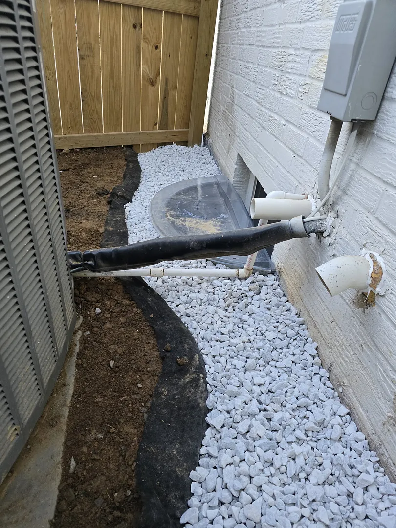 Bethesda, MD Foundation Leak: Exterior Waterproofing and Grading Tile 7 Restored stone and mulch around the basement window well and A/C equipment