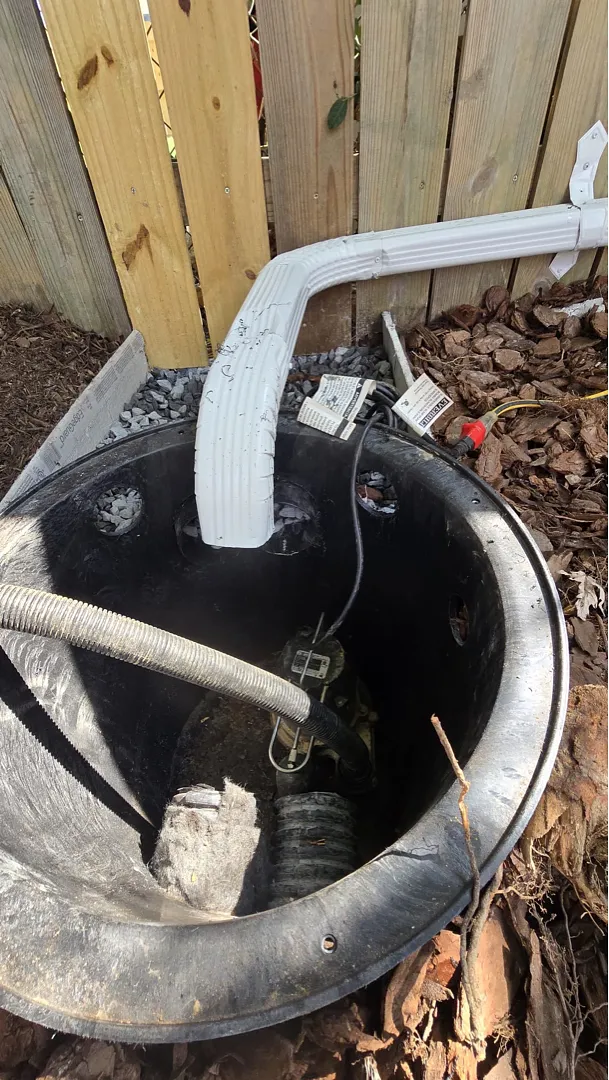 Open Alexandria sump pit with equipment and piping during installation