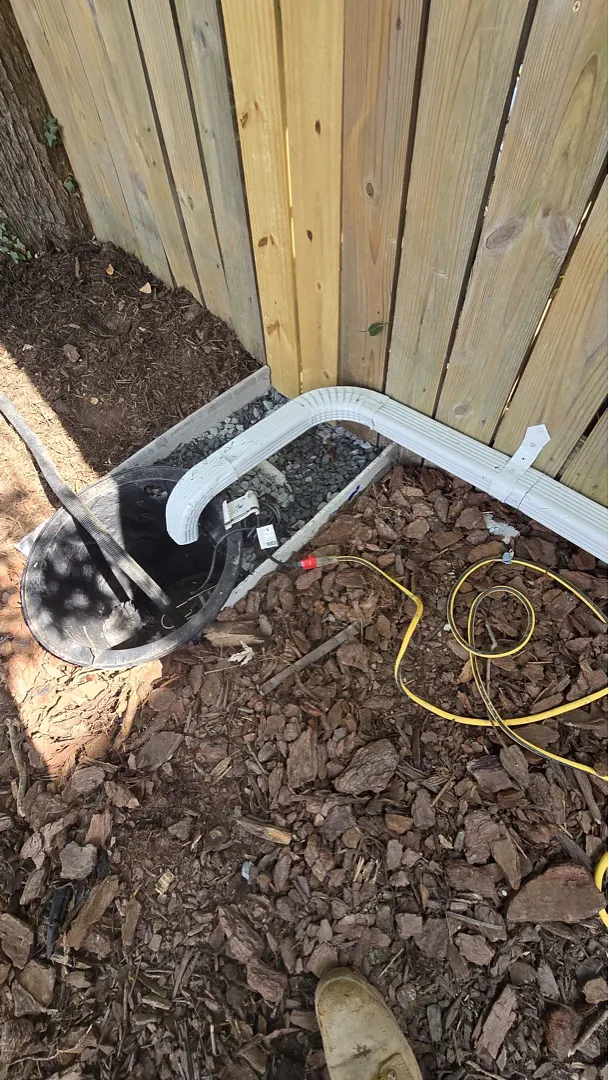 Open sump basin and white pipe during Alexandria drainage installation