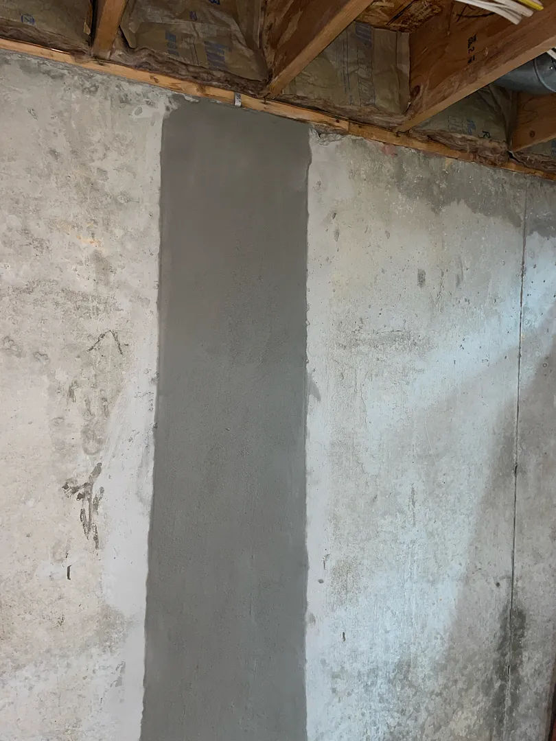 Gaithersburg, MD Foundation Crack Injection: A Later Repair at the Same Home 2 Gray patched strip on the Gaithersburg basement wall after the later crack-injection job