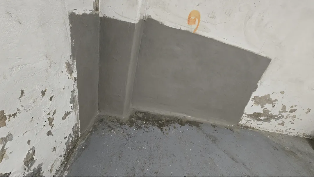 Foggy Bottom, DC Basement Wall Crack Injection: Real Repair Photos 2 Gray cementitious patch at a basement wall corner after localized repair in Foggy Bottom, DC