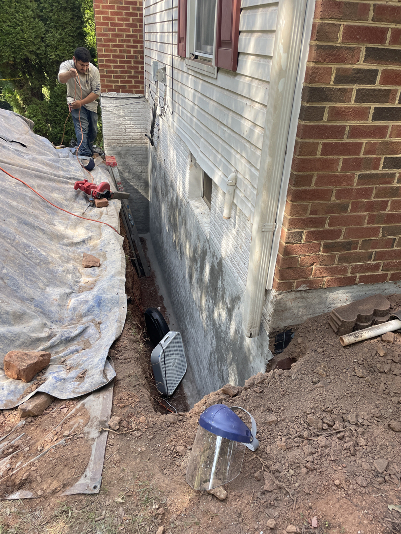 Exposed Sterling foundation wall beside the excavation before sheet membrane installation