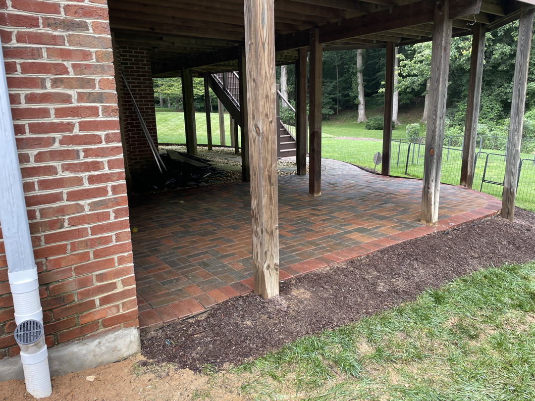 Restored backyard area beneath a raised deck after the waterproofing work
