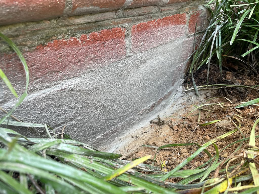 Basement Vent Leak Repair in Potomac, MD | Real Case 3 Close view of finished cementitious seal at the low exterior vent