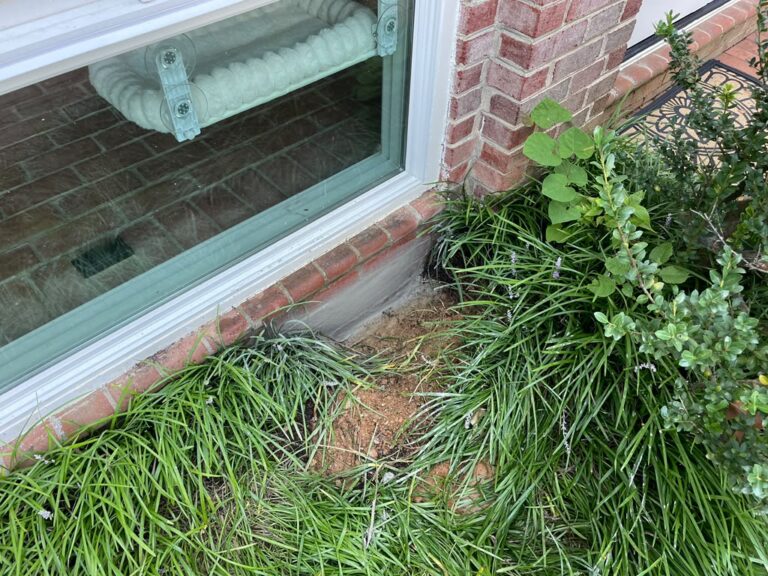 Finished sealed exterior vent area beneath a basement window in Potomac, Maryland