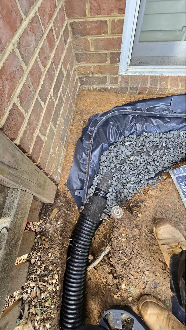 Membrane, gravel and drain pipe at the near-grade Dunn Loring drainage trench
