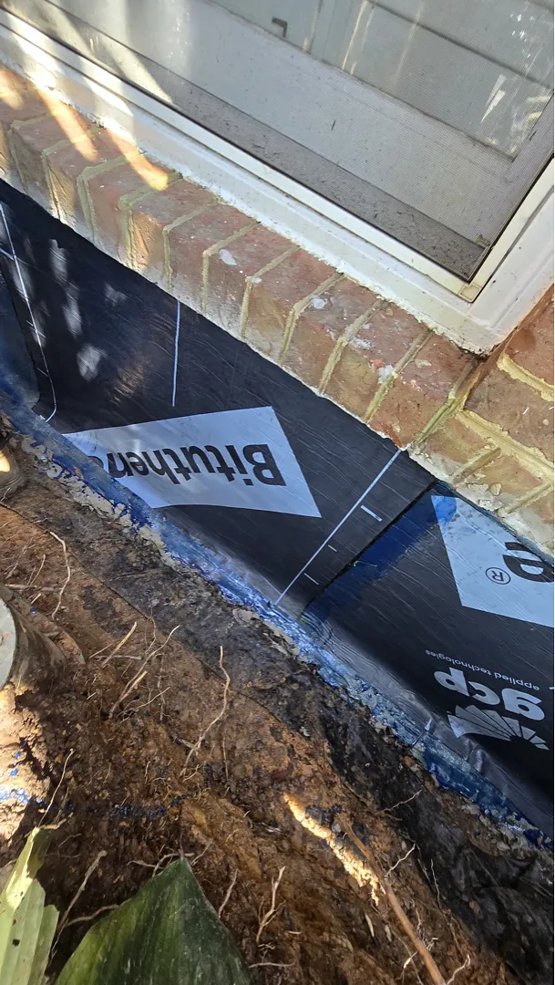 Black sheet membrane installed beneath the basement window
