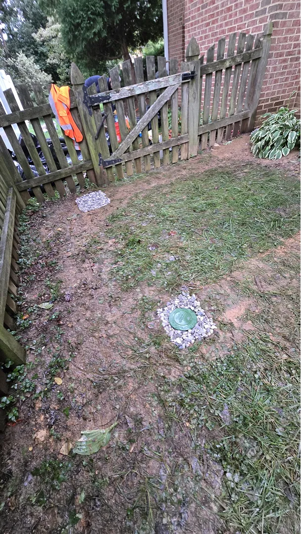 Restored yard with visible drainage outlets after the Dunn Loring project