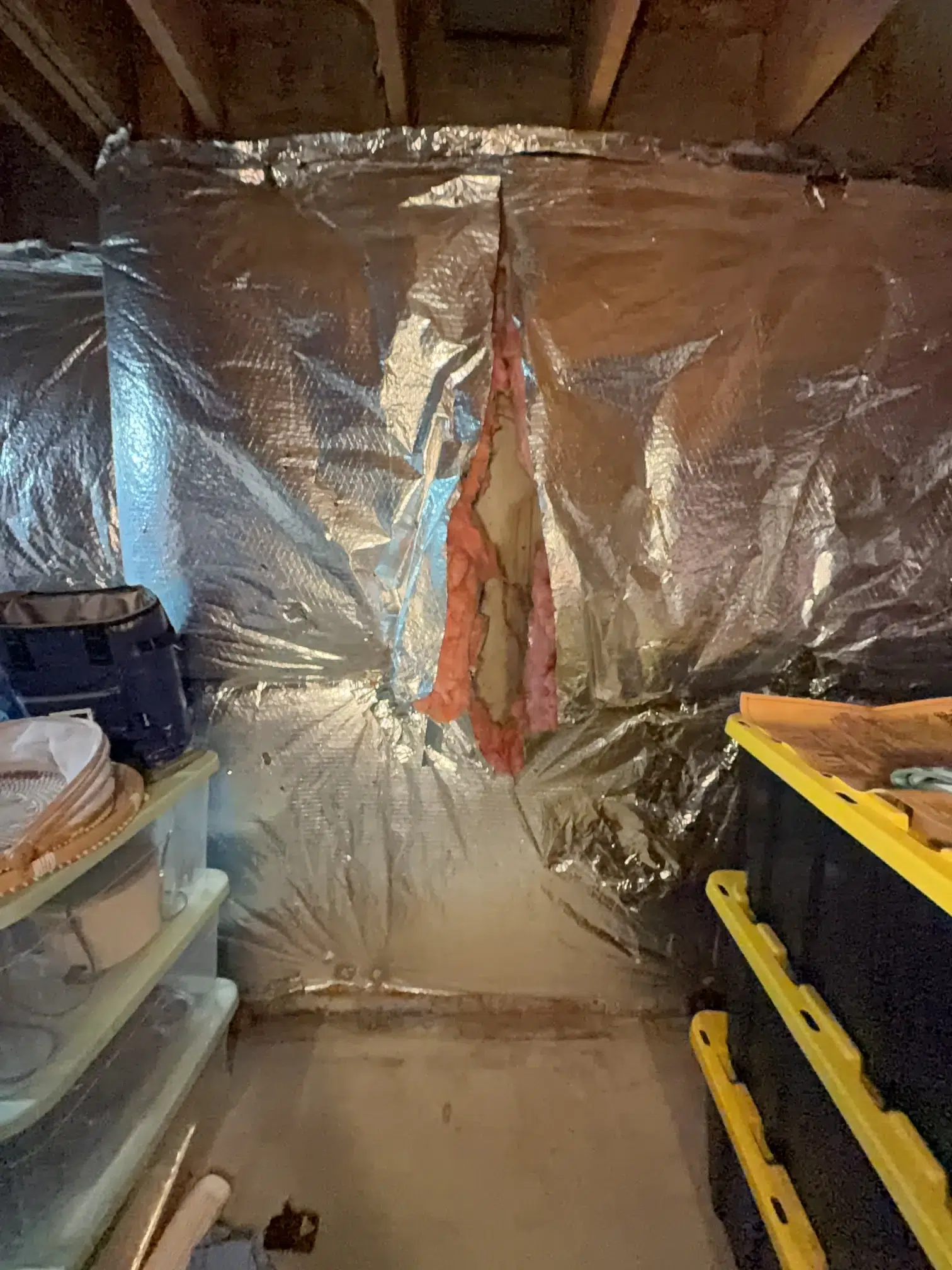 Concrete Foundation Crack Repair in Gaithersburg, MD | Polyurethane Injection Case 1 Foil-faced insulation opened to expose a poured-concrete basement wall before crack injection in Gaithersburg, MD