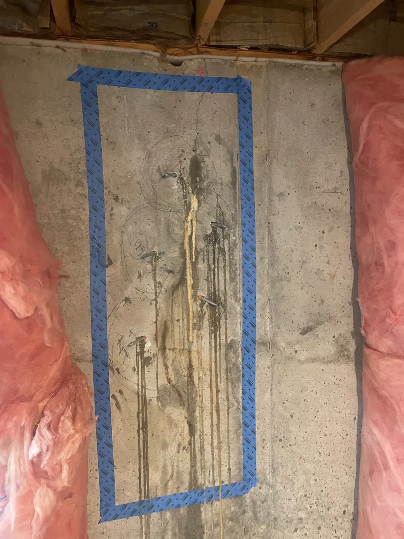 Concrete Foundation Crack Repair in Gaithersburg, MD | Polyurethane Injection Case 2 Exposed vertical crack with injection packers and staining on a poured-concrete basement wall in Gaithersburg, MD