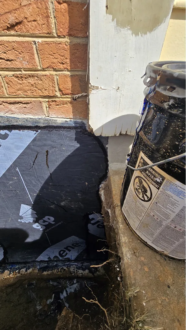 Black self-adhered sheet membrane on the foundation wall