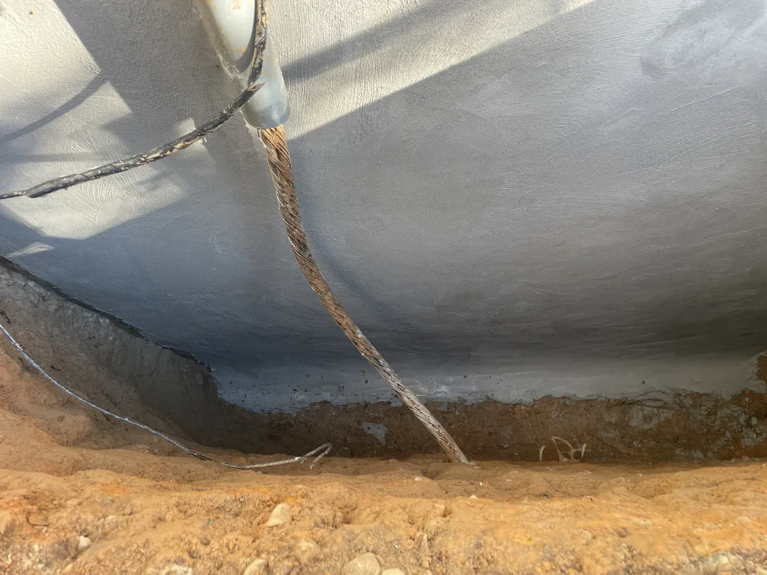 Polymer-modified cementitious waterproofing coat on the foundation wall