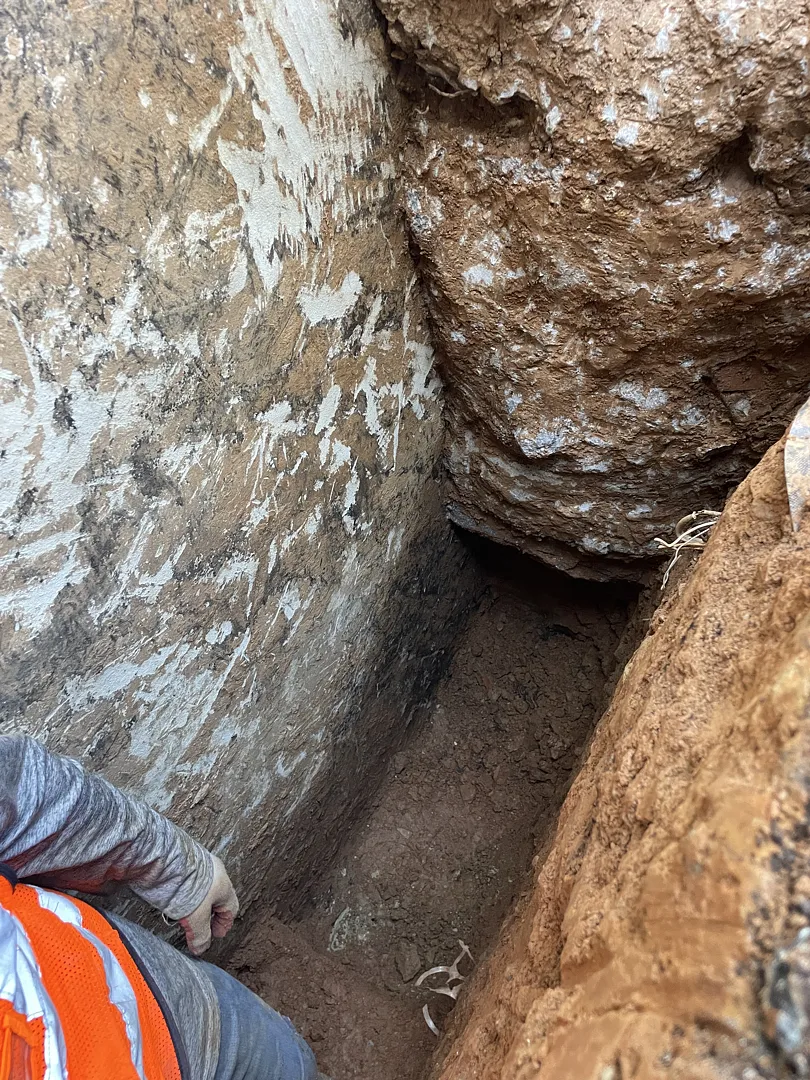 Exposed foundation masonry beside basement window well in Rockville